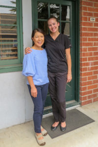 two office staff by office door